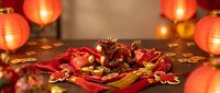 Ornamental red and gold dragon figurine surrounded by glowing lanterns and festive decorations, ideal for lunar new year celebrations and traditional holiday designs.