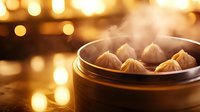 Steaming hot dumplings in bamboo steamer with golden bokeh lights background, traditional Asian cuisine with rising steam and warm atmosphere.