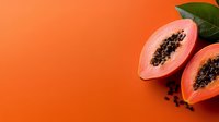 Fresh halved papaya showing black seeds and coral flesh on vibrant orange background with green leaves, minimalist food composition for healthy eating concept.