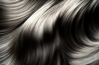 Flowing waves of silver and dark gray hair strands create abstract pattern with smooth curves and glossy highlights. Macro photography shows detailed texture.