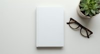Blank white notebook with eyeglasses and succulent plant on neutral background for workspace mockup and office stationery design projects.