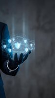Businessman in dark suit holding glowing digital shield network with interconnected security icons, representing cybersecurity, data protection, and network defense technology solutions.