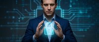 Professional businessman in dark suit holding glowing digital shield symbol representing cybersecurity and data protection in modern tech environment.