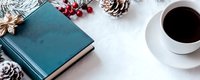 Cozy winter flat lay with teal notebook, coffee cup, pine cones and red berries on white background for seasonal planning and journaling concepts.
