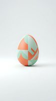 Modern Easter egg with coral and mint green geometric pattern on white background for spring holiday decorations and seasonal design projects.