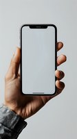 Hand holding smartphone with blank white screen mockup for app presentation and mobile interface design projects.