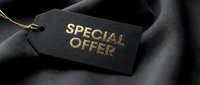 Black luxury price tag with gold foil Special Offer text on dark silk fabric background, elegant retail and fashion promotion concept.