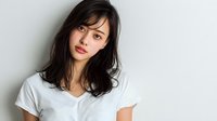 Young Asian woman with long dark hair wearing white t-shirt against neutral background, looking directly at camera with natural expression.