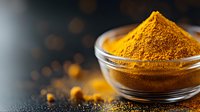 Ground turmeric powder in glass bowl on dark background with scattered spice and golden bokeh lights, macro food photography for cooking and health.