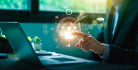 Business professional touching glowing lightbulb icon with gear symbols representing innovation and creative problem-solving in modern office environment.
