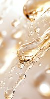 Liquid drops and splashes in golden light creating dynamic flow pattern with bubbles and droplets against soft beige background. Macro photography of water motion.