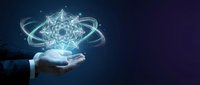 Businessman hand holding glowing geometric sacred geometry symbol with orbiting light particles on dark blue background for technology and innovation concepts.