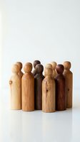 Wooden peg dolls in various natural wood tones arranged in a circle, representing diversity and unity. Suitable for concepts of teamwork, community, and inclusion.