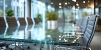 Modern glass conference table in empty corporate meeting room with leather chairs and decorative plants in background.