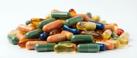 Colorful pharmaceutical capsules and pills scattered on white background for medical healthcare and treatment concepts.