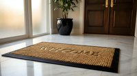 Welcome doormat on marble floor at home entrance with wooden door and plant in background, warm inviting atmosphere.