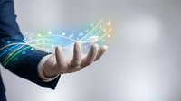 Businessman holding glowing digital icons and data streams, symbolizing innovation, connectivity, and modern technology in business.