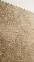 Textured beige wall surface with rough stucco finish for interior design and architectural backgrounds.