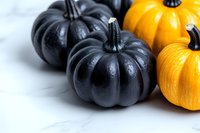 Black and orange decorative pumpkins on white background, seasonal autumn composition with dramatic lighting and selective focus for Halloween decor.