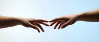 Two hands reaching toward each other against soft sky background symbolizing connection, unity, teamwork, partnership, support, help, and human relationships.