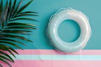 Metallic silver pool float ring on pastel pink and turquoise background with tropical palm leaf, minimal summer composition for beach and pool party design.