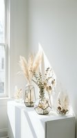 Minimalist home decor with dried pampas grass and eucalyptus in geometric glass vases on white shelf near window for modern interior design styling.