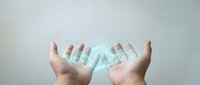 Hands holding glowing DNA double helix structure representing genetic research, biotechnology innovation, and molecular science concepts for medical studies.
