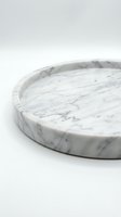 Round white marble tray with gray veining, elegant stone serving platter on light background, luxury home decor and kitchen accessory.