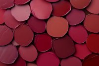 Colorful lipstick samples in various red and pink shades arranged as makeup palette for cosmetic industry and beauty applications.