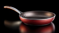 Red non-stick frying pan with stainless steel handle isolated on black background, professional cookware for home kitchen and restaurant use.
