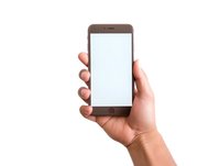 Female hand holding modern smartphone with blank white screen mockup isolated on white background for app and web design presentation.