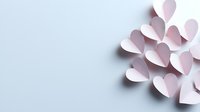 Delicate paper hearts in soft pink arranged artistically on light background creating gentle shadows and depth. Minimal Valentine's day or wedding design element.