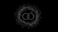 Elegant wedding rings surrounded by ornate floral wreath with decorative swirls on black background for romantic invitations and ceremony designs.