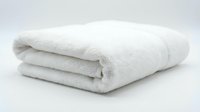 Soft white fluffy bath towel neatly folded on a light background, showcasing clean cotton texture for spa, hotel, and home decor concepts.