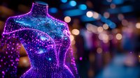 Glowing mannequin torso with sparkly purple and blue neon lights against dark background with bokeh effect creates magical fashion display atmosphere.