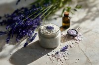 Natural lavender spa treatment with homemade scrub, essential oil and fresh flowers on rustic wooden surface for relaxation and aromatherapy wellness.