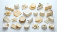 Assorted gourmet cheese varieties including brie, cheddar, gouda and blue cheese arranged on white background for culinary and food photography.