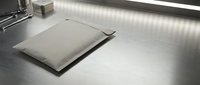 Industrial stainless steel floor scale in modern commercial kitchen environment for precise weight measurement and food service operations.