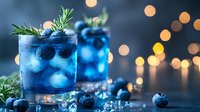 Blue cocktail garnished with fresh blueberries and rosemary sprig in glass, festive bokeh lights background, refreshing summer drink with ice cubes.