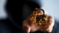 Glowing golden padlock with magical sparkles floating above outstretched hand against dark background, representing digital security and data protection concepts.