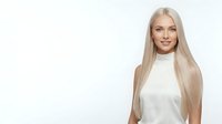 Young woman with long platinum blonde hair, fair complexion, and Caucasian ethnicity wearing white sleeveless top against neutral background. Suitable for beauty, hair care, wellness and lifestyle marketing.