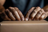 Hands of African American craftsman working with clay, shaping pottery on wheel. Professional ceramic artist creating handmade vessel in studio workshop.