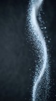 White powder explosion with sparkling particles flowing in dynamic wave motion against dark background for creative design projects.