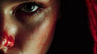 Close-up portrait of young woman with dramatic makeup featuring fake blood effects and intense gaze for horror themed creative projects.