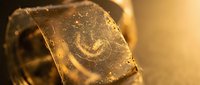 Luxury golden chocolate bar with cocoa powder dusting melting in warm ambient light creating indulgent confectionery mood for gourmet dessert marketing.