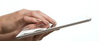Close-up of hands holding and using a tablet device on white background, suitable for technology, business, and digital communication concepts.