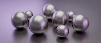 Metallic spheres with brushed silver and purple gradient finish arranged on reflective surface for modern design projects.