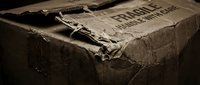Vintage weathered cardboard box with torn edges and aged paper texture in sepia tones, perfect for antique storage and nostalgic design projects.