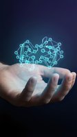 Hand holding glowing cyan molecular structure against dark background, representing scientific innovation, biotechnology research, and advanced technology development for business and education.