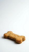 Bone-shaped dog treat made from whole grain ingredients with visible texture, isolated on white background for pet food packaging and veterinary use.